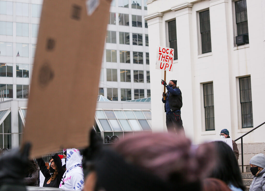 Fred Johnson, a member of the Spanish Lake Township Democratic Party, holds a sign